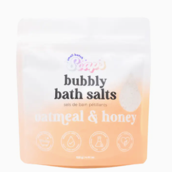 Bottle of bubbly bath salts with a gradient label from white to peach, featuring the brand 'Pompei'.