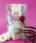 Herbal tea packaging with 'Bush Berry' branding on a pink background