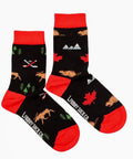 Two black socks with red accents featuring nature-themed designs on a white background.