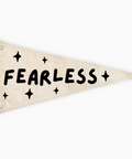 A triangular pennant flag in a distressed cream color with the word 'FEARLESS' and star accents printed in black, shown on a plain white background.