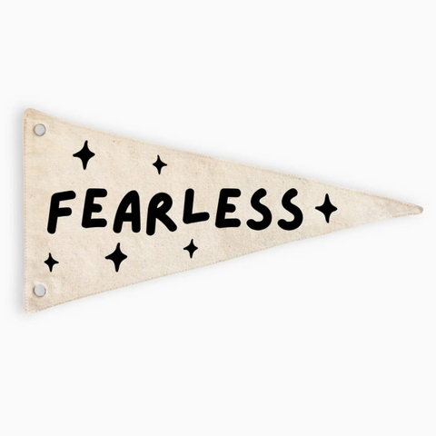 A triangular pennant flag in a distressed cream color with the word 'FEARLESS' and star accents printed in black, shown on a plain white background.
