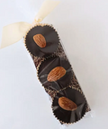 Chocolate bars with almonds in a decorative box on a light background