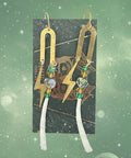 Pair of gold earrings with green and clear stones on a dark surface