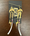Decorative hair accessory with gold design on a wooden surface