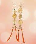 Set of earrings on a branded card on a wooden surface