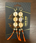Set of earrings on a branded card on a wooden surface