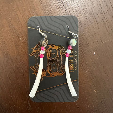 Set of earrings on a branded card with a wooden surface background