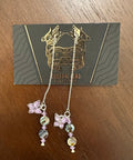 Jewelry set with charms on a card on a wooden surface