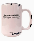 Pink mug with black text and design on a white background