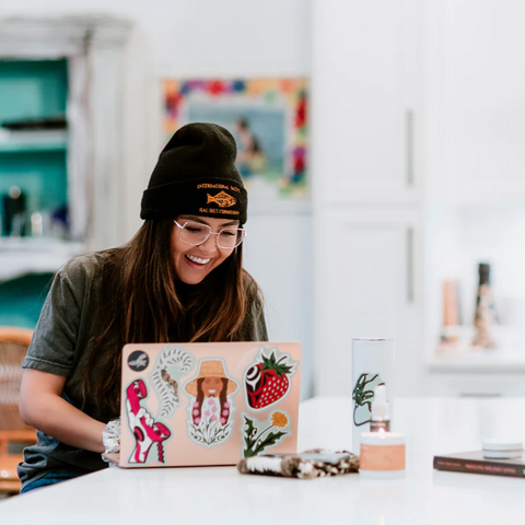 Computer screen displaying a web page with a person using a laptop and a product image on the screen.