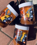 Three clear containers with toy construction vehicles on a textured surface
