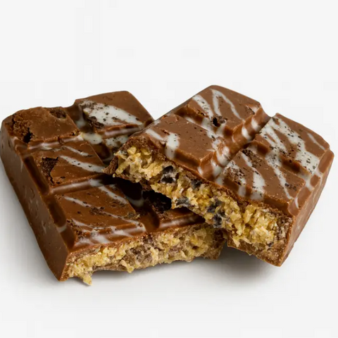 Chocolate-covered cookie dough bar with a bite taken out on a white background