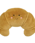 Plush pillow shaped like a brown bread roll with a face on a white background