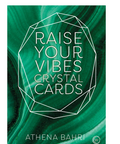 Front cover of the card deck product titled 'Raise Your Vibes Crystal Cards' by Athena Bahri, featuring a green marbled background with a white outlined geometric crystal shape and white text.