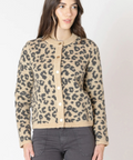 Woman wearing a leopard print cardigan on a white background
