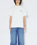 Person wearing a white t-shirt and blue jeans on a plain background