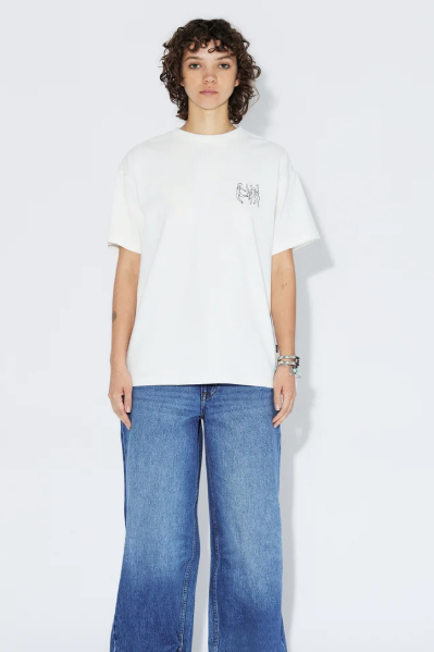 Person wearing a white t-shirt and blue jeans on a plain background