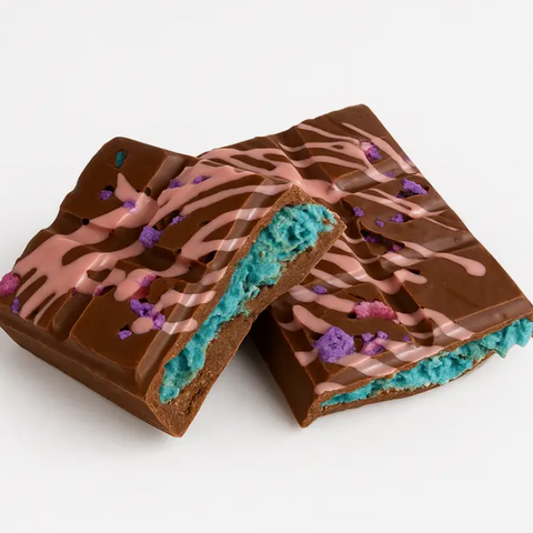 Chocolate bar with colorful drizzle and sprinkles on a white background