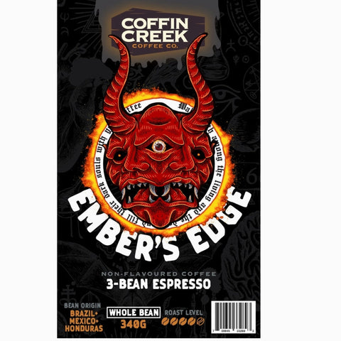 Coffin Creek Coffee Co. Ember's Edge coffee package with a red demon-like face design on a black background.
