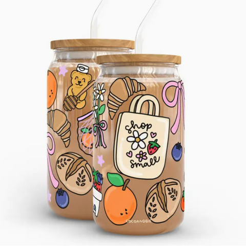 Two glass jars with wooden lids, decorated with colorful illustrations on a white background.