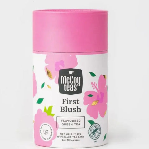 Tea canister with pink lid and floral design on a white background