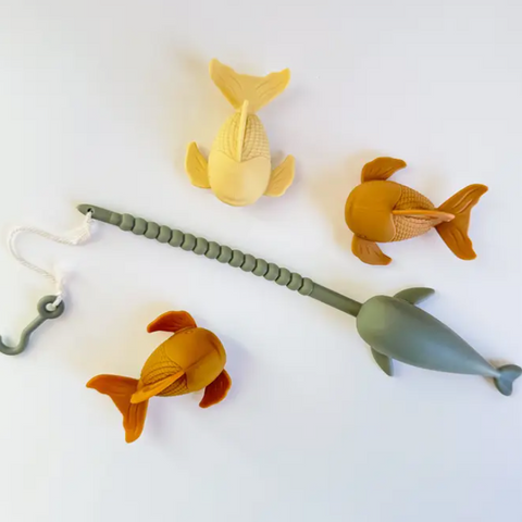 Set of colorful toy fish and hook on a white background