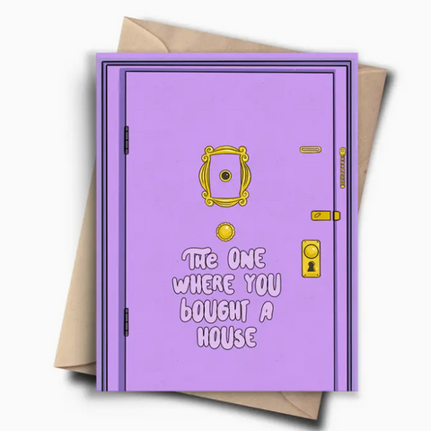 Purple door card with gold handle and text 'The One Where You Bought a House' on a white background