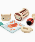 Set of baby toys including a rattle, teether, and soft book on a white background