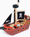 Toy pirate ship with figures and flags on a white background