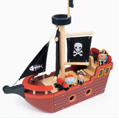Toy pirate ship with figures and flags on a white background