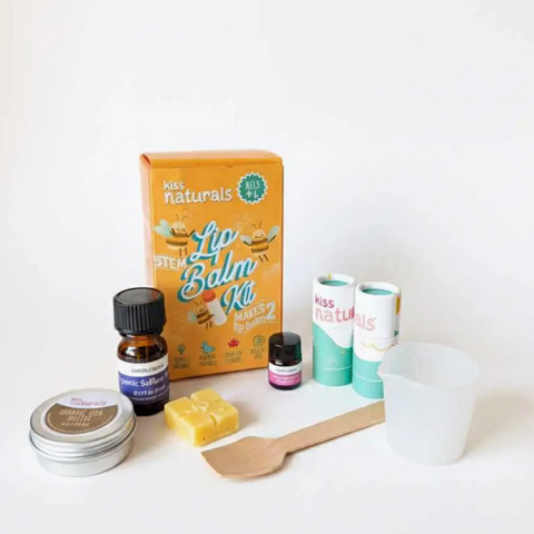 Kiss Naturals lip balm kit with various ingredients and tools on a white background