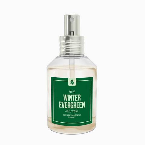 Clear spray bottle labeled 'Winter Evergreen' on a white background
