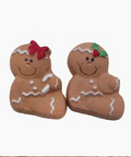 Two gingerbread cookie-shaped figurines with decorative elements on a white background