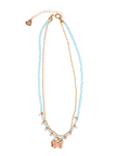 A double-strand necklace featuring light blue faceted beads and rose gold metal chains, with a butterfly charm and a small heart charm at the center, displayed on a solid white background.