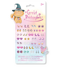 A package of 'Great Pretenders' 3D stick-on earrings for kids, featuring a cute orange cat wearing a witch hat illustration on the card. The package contains 30 pairs of pastel-colored, whimsical earring charms shaped like stars, moons, hearts, and crystals, shown against a clean white background.