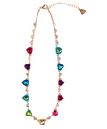 A gold-tone chain necklace featuring multiple colorful heart-shaped rhinestones in red, blue, green, and pink, with a small gold heart at the center, shown on a plain white background.