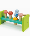 Colorful wooden toy set with mushrooms and a bird on a green base.