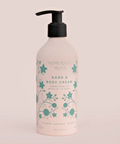 Hand and body cream bottle with floral design on a beige background