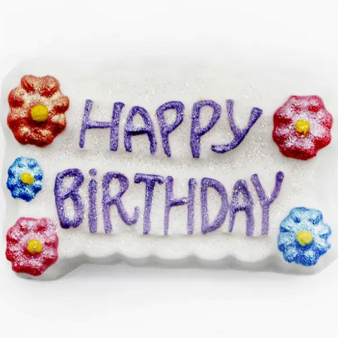 Decorative stone with 'Happy Birthday' text and floral designs on a white background