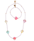 A pastel beaded necklace and bracelet set with iridescent heart-shaped beads and gold-tone hardware, displayed on a clean white background.