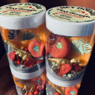 Two jars with decorative elements on a wooden surface