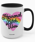 Mug with 'Hormonal Bitch Vibes' text inside a heart on a white background