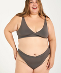 Woman wearing a gray bikini set on a white background