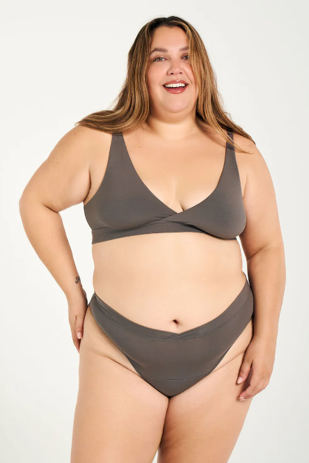 Woman wearing a gray bikini set on a white background