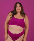 Woman wearing a pink bikini against a purple background