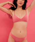 Woman wearing a pink bikini against a pink background