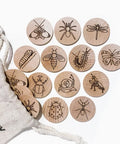 Wooden buttons with insect illustrations on a white background