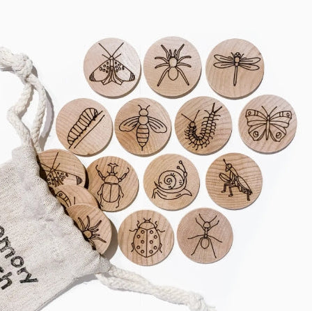 Wooden buttons with insect illustrations on a white background