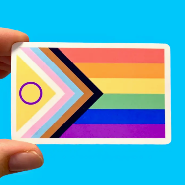 Colorful card with rainbow design held by a hand against a blue background