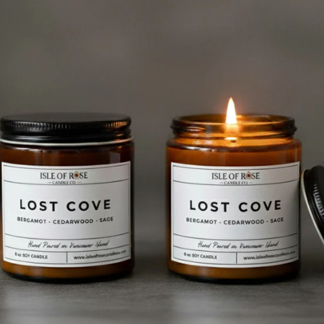 Two candles labeled 'Lost Cove' by Isle of Rose Candles on a gray background